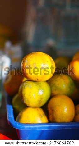 stacked sweet and ripe yellow oranges