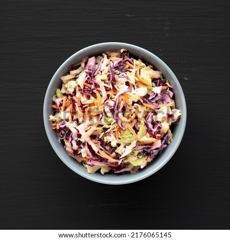 Homemade Coleslaw with Cabbage and Carrots in a Bowl, top view. Flat lay, overhead, from above. Royalty-Free Stock Photo #2176065145