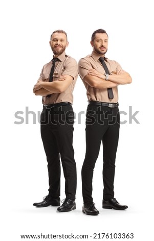 Full length portrait of two security guards posing with crossed arms isolated on white background