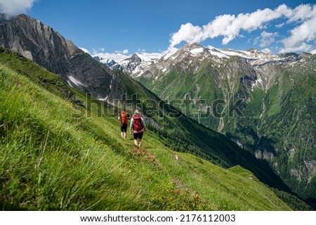 Couple hiking on a mountain trail in the Hohe Tauern, Kaprun, Salzburger Land, Austria, Europe Royalty-Free Stock Photo #2176112003