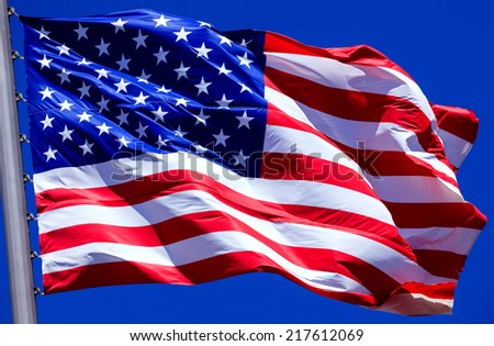 Flag of the USA against a blue sky 