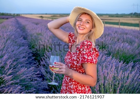  Beautiful blonde woman posing for pictures outdoors in a picturesque lavender field.