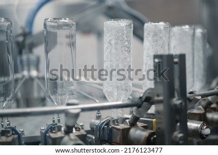 washing machine bottle vodka pre-rinsing processautomated workshop of production plant extreme closeup