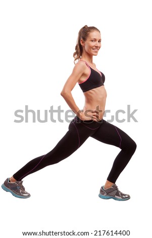 Young beautiful fitness girl doing exercise isolated on white