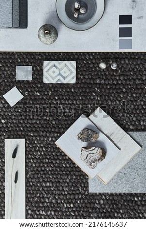 Stylish flat lay composition of architect moodboard with samples of building, brown textile and natural materials and personal accessories. Top view, template.