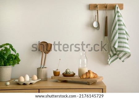 Interior design of kitchen space with rattan commode,  ladder, baking, food and kitchen accessories in modern home decor.  Template. 