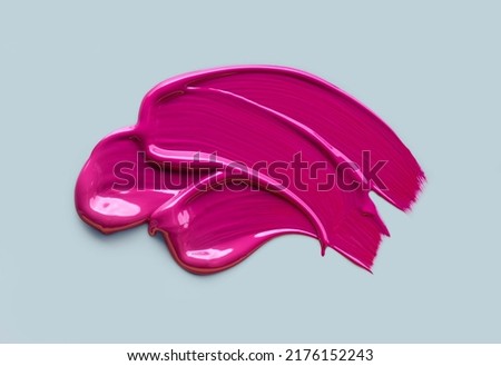 Palette of lip gloss deep pink texture isolated on deep pink background