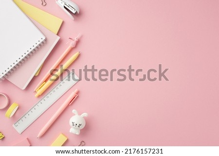 Back to school concept. Top view photo of stationery note pads pens bunny shaped sharpener adhesive tape ruler mini stapler and erasers on isolated pink background with copyspace