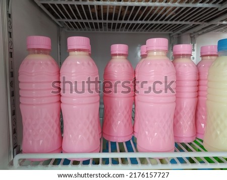 fresh plain and strawberry milk on plastic bottles. 
