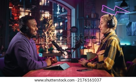 Two Young Stylish Radio Show Hosts Record Fresh Podcast Episode in Home Loft Studio Apartment. Attractive Energetic Co-hosts Discuss Important Topics Live on Air in an Evening Show.