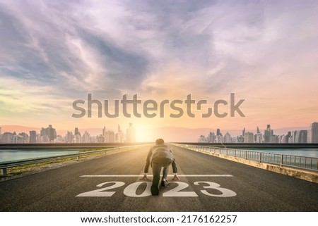 businessman person ready to run 2023 toward the city. Business start-up concept. Royalty-Free Stock Photo #2176162257