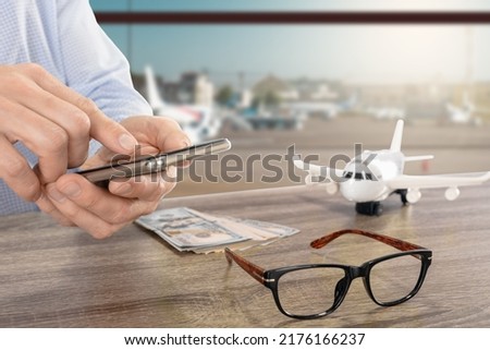 Closeup photo of young man searching flight schedule for his trip