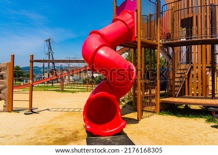 Playground equipment in the park under the summer sky