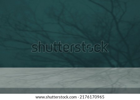 Marble Table with Bokeh and Branch Shadow on Concrete Wall Texture Background in Tidewater Green Tone, Suitable for Product Presentation Backdrop, Display, and Mock up in Halloween Concept. Royalty-Free Stock Photo #2176170965