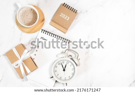 Calendar 2023 and alarm clock on office table. to-do list and plan for next year. flatlay composition Royalty-Free Stock Photo #2176171247