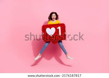 Full body photo of cool millennial brunette lady jump with pinata wear t-shirt jeans sneakers isolated on pink background