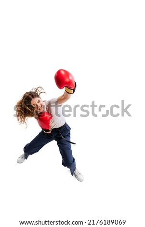 Full-length portrait of young woman, employee in office cloth and boxing gloves isolated over white studio background. Fighting for promotion. Concept of business, success, growth, cooperation