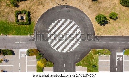 Aerial view on a roundabout road junction Royalty-Free Stock Photo #2176189657