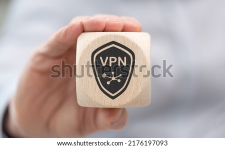 Hand holding a wooden cube with symbol of vpn concept