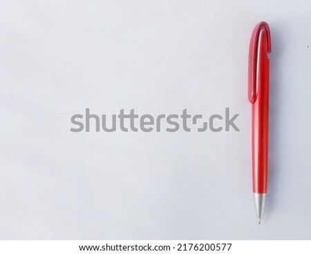 red pen or ballpoint pen on a white background. used by teachers, students, employees to write, sign, work in the office