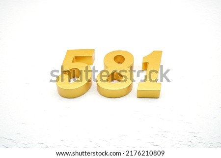 Number 581 is made of gold painted teak, 1 cm thick, laid on a white painted aerated brick floor, visualized in 3D.                                                   