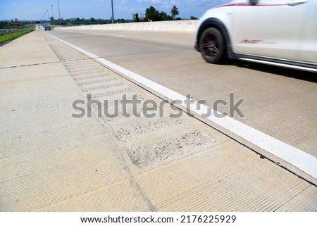 Scratches on concrete Made to warn  against out of the lane when drowsy.Traffic signals.