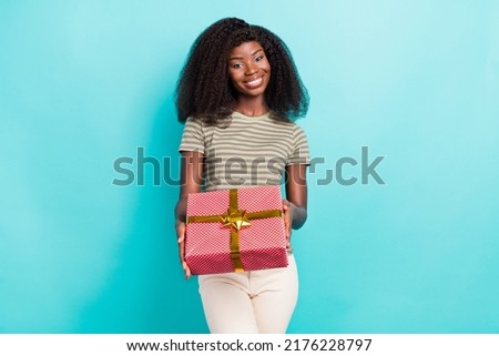 Photo of pretty positive person hands hold giftbox ribbon bow toothy smile isolated on vibrant emerald color background