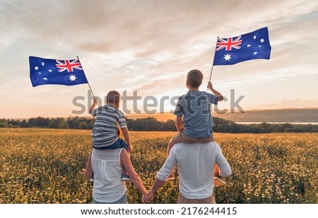 A Patriotic family waving Australia flag on sunset Royalty-Free Stock Photo #2176244415