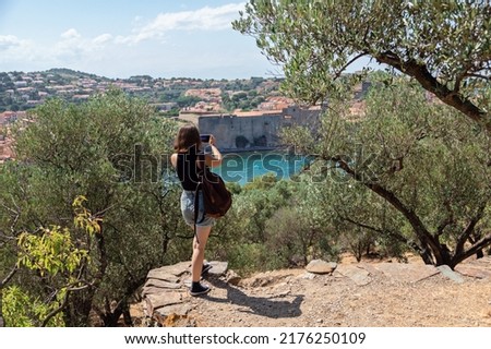 Young girl tourist making pictures on her trip, lifestyle, adventre, sustainable tourism concept, traveler with backpack. Young hiker on her summer vacations