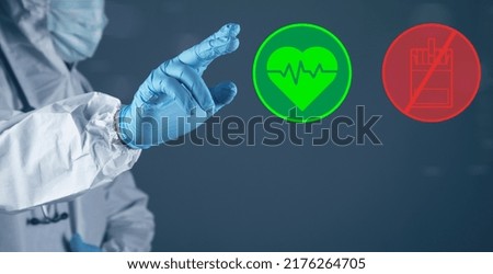 Illustrated healthy heart and pack of cigarettes. The doctor clicks on the screen