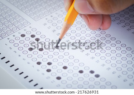 hand fill in Exam carbon paper computer sheet and pencil Royalty-Free Stock Photo #217626931