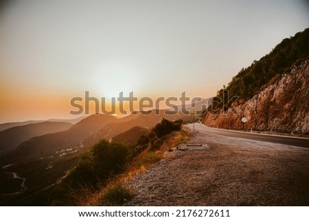 A road on the mountain on the sunset Royalty-Free Stock Photo #2176272611