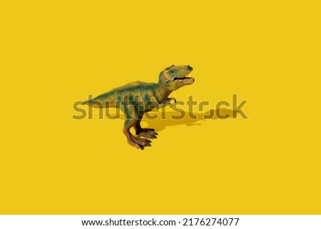Dinosaurs Tyrannosaurus rex on a yellow background. T-rex toy.
