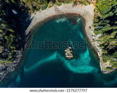 Aerial Argentinian patagonia landscape with turquoise lakes, rocks, and pine trees