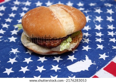 Pork burgers placed on American flag-themed fabric.