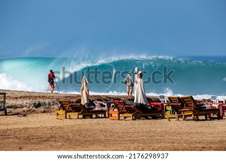 Photographer taking photos of big and perfect wave at Puerto Escondido, Mexico