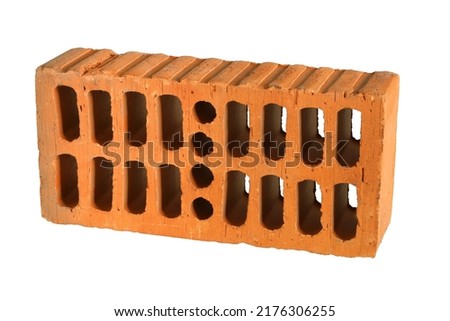 Red construction brick block with perforation, single textured object isolated on white background