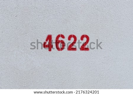 Red Number 4622 on the white wall. Spray paint.
