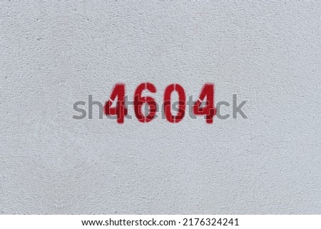 Red Number 4604 on the white wall. Spray paint.
