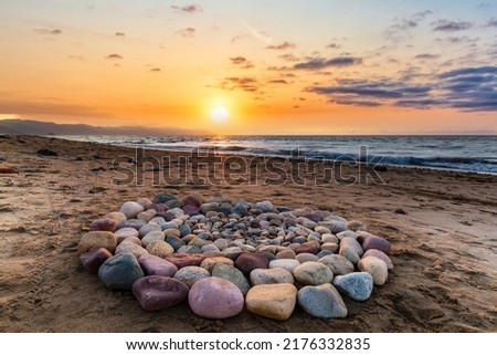 Ritual Stones For Spiritual Ceremony Are Are Arranged In A Circle During Sunset On The Beach Royalty-Free Stock Photo #2176332835