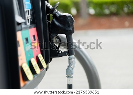 Gas pump at an American gas station with a black nozzle and colorful fuel option buttons oil petrol gasoline Royalty-Free Stock Photo #2176339651