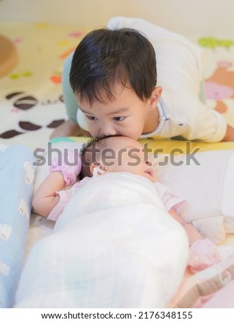 Big Brother Looking at his Newborn Baby, Sibling relationship Royalty-Free Stock Photo #2176348155