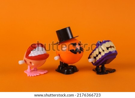 Clockwork halloween toy monsters on orange background