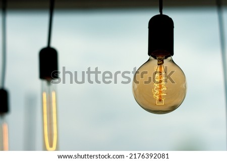 Close up image of a retro style light bulb. Royalty-Free Stock Photo #2176392081