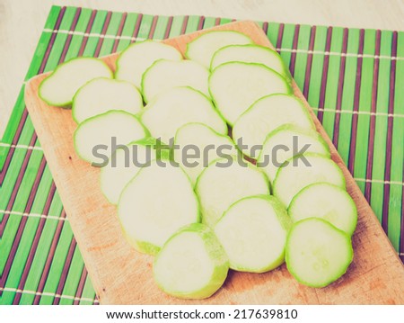 vintage photo of fresh cut cucumbers on wooden table