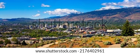 Downtown Reno skyline, Nevada, with hotels, casinos and the surrounding High Eastern Sierra foothills Royalty-Free Stock Photo #2176402961