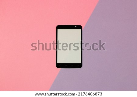 mobile phone with copy space on pastel pink-purple background, creative modern design, techno background