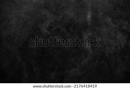 Dark cement wall in retro concept. Black concrete background for wallpaper or graphic design. Blank old plaster texture in vintage style. Abstract surface with unusual beautiful patterns. Royalty-Free Stock Photo #2176418419