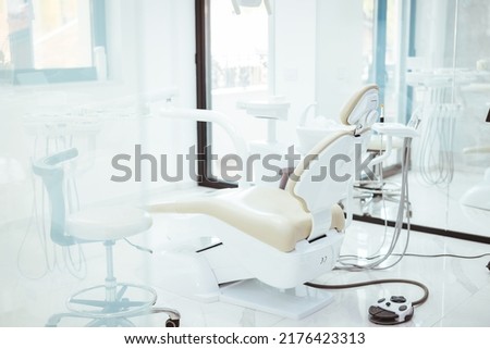 Dentistry, medicine, medical equipment and stomatology concept - interior of new modern dental clinic office with chair. Interior of the office of patients reception with dental equipment