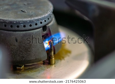 small gas flame on the stove in the kitchen